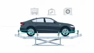 Car undergoing wheel alignment on auto shop lift