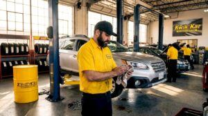 Auto technician working in oil change garage