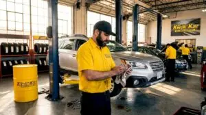 Auto technician working in oil change garage
