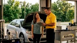Technician talking with customer in repair shop