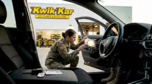 Military member checking car at inspection station