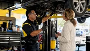 Technician explaining car repair to customer