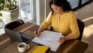 Woman reviewing car repair estimates at table