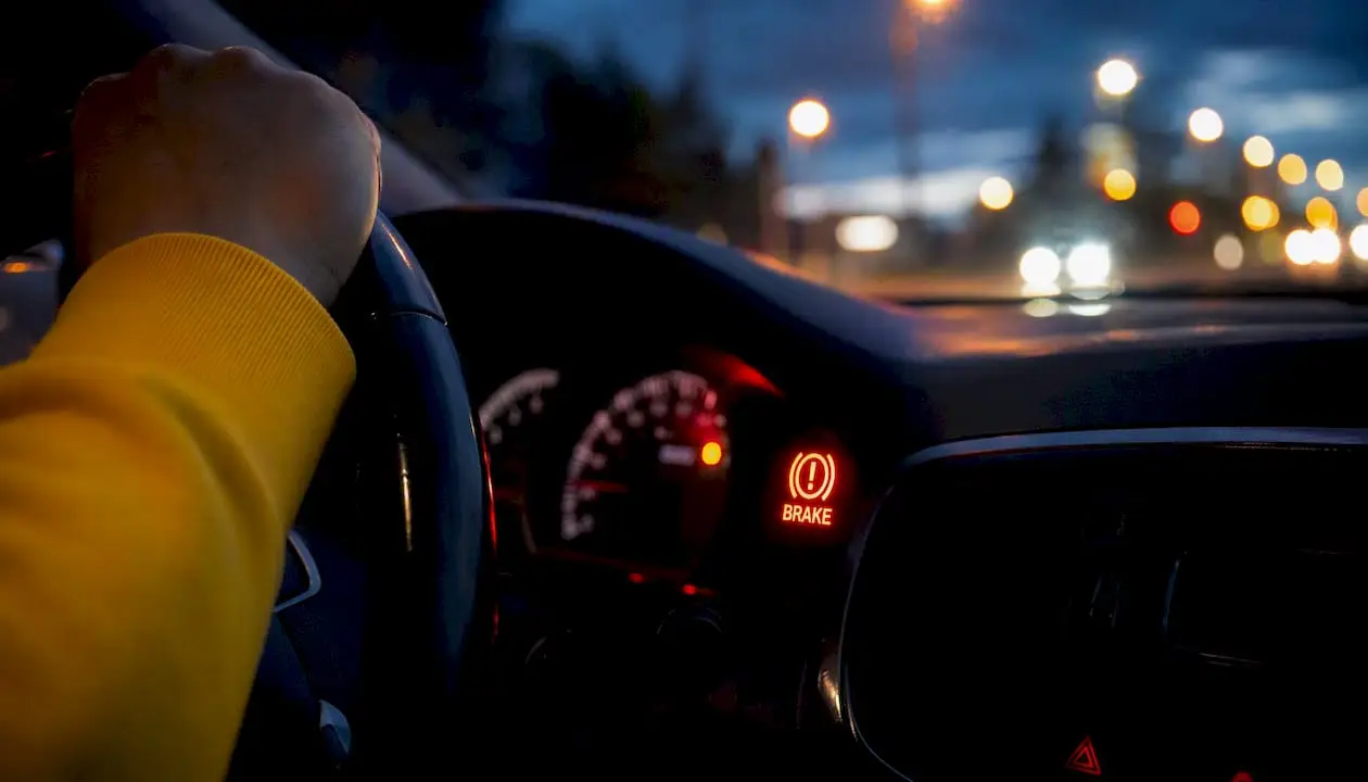 Car dashboard brake fluid warning light at night