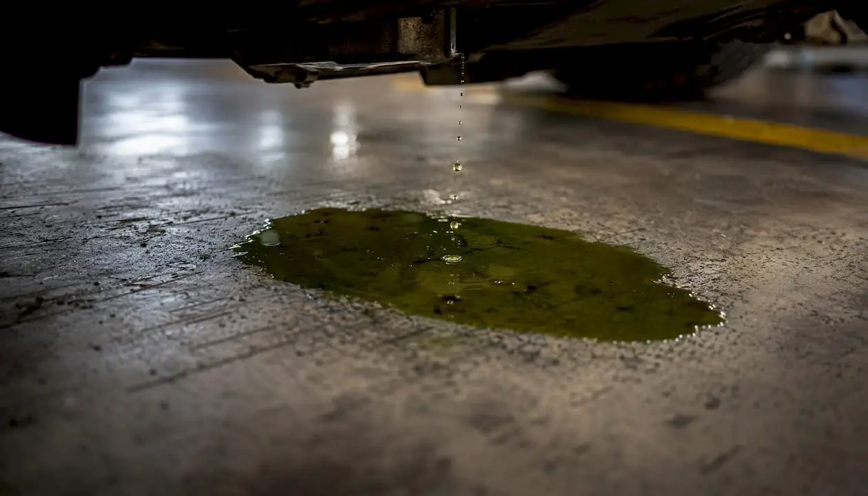 Coolant puddle on garage floor under car
