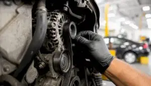 Technician checking alternator serpentine belt