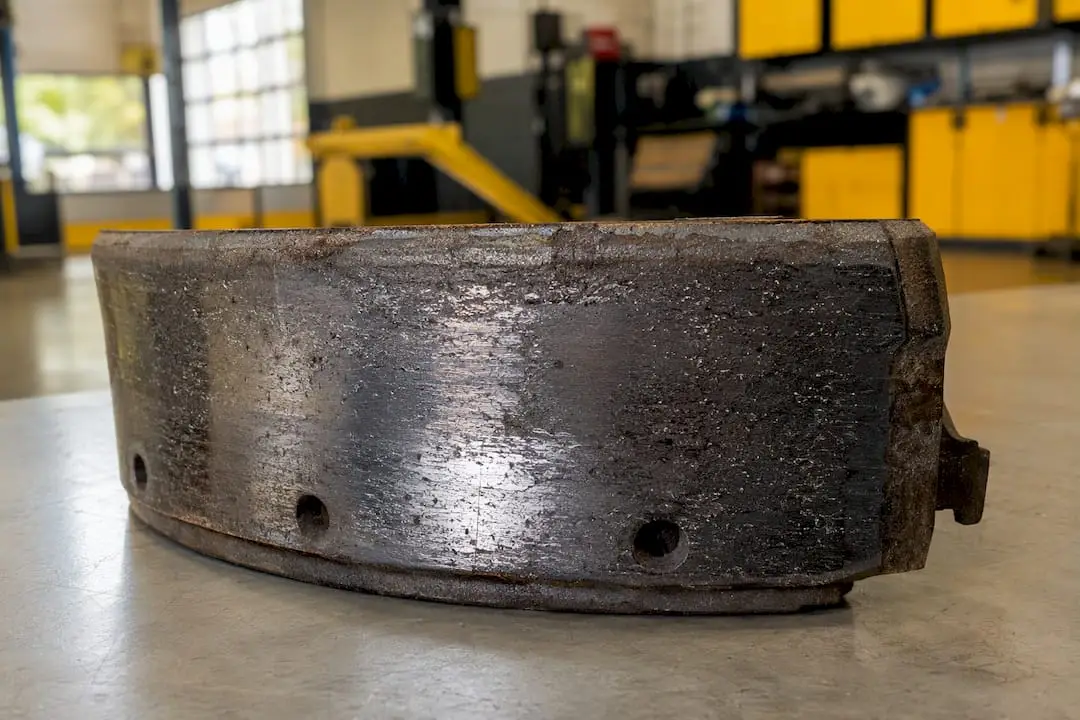 Close-up of glazed, damaged brake lining surface