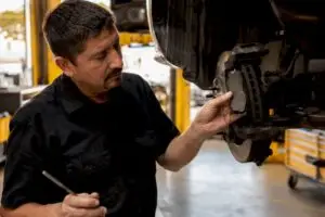 Close-up brake lining inspection by technician