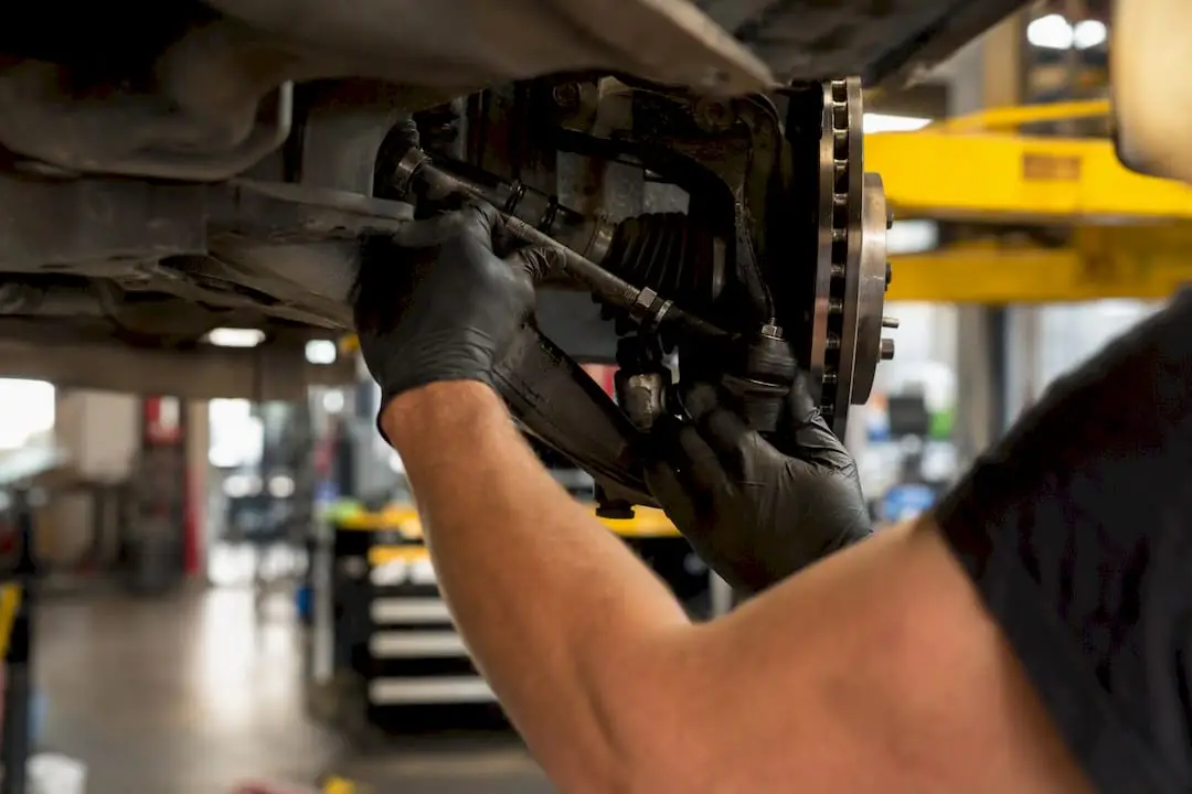 Technician inspecting vehicle suspension and wheel balance