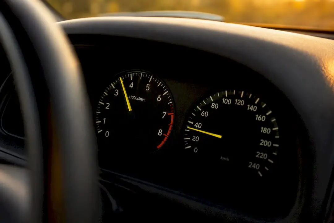 Car dashboard showing tachometer and speedometer during acceleration