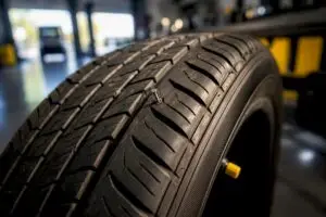 Nail embedded in tire tread close-up