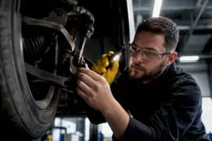 Technician inspecting anonymous suspension components