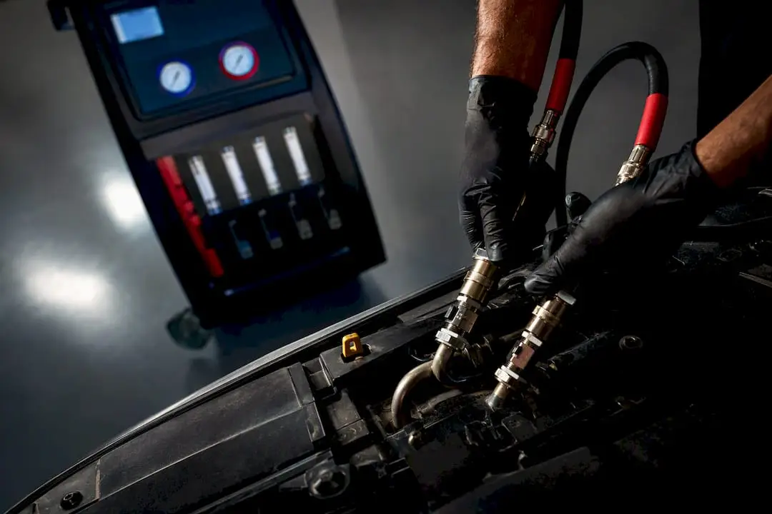 Technician connecting transmission fluid service hoses