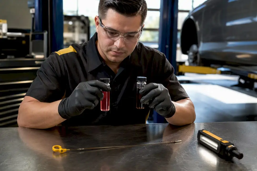 Technician comparing transmission fluid samples