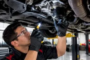 Technician inspecting oil filter gasket seam