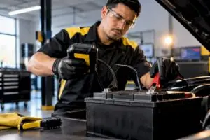 Technician testing an automotive battery