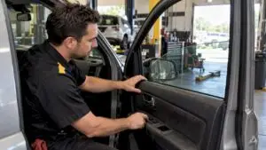 Technician diagnosing a stuck power window