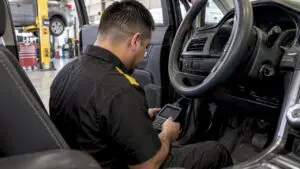 Technician checking OBD readiness with a scan tool